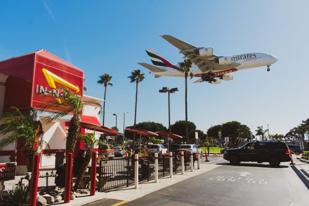 an airplane is flying over a mcdonald's restaurant